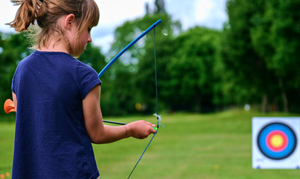 girl learning how to shoot through bow and arrow